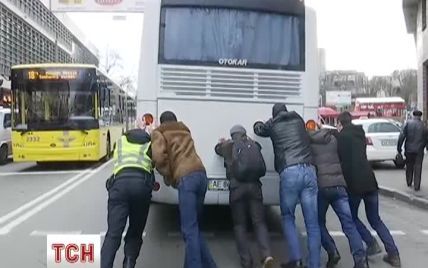 Поліцейський із "бджілками" штовхали автобус в центрі Києва