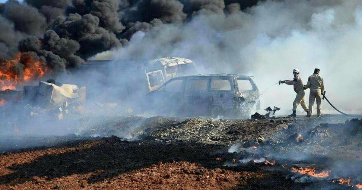 Активисты гражданской обороны тушат пожар после авиаудара по рынку топлива в провинции Идлиб.