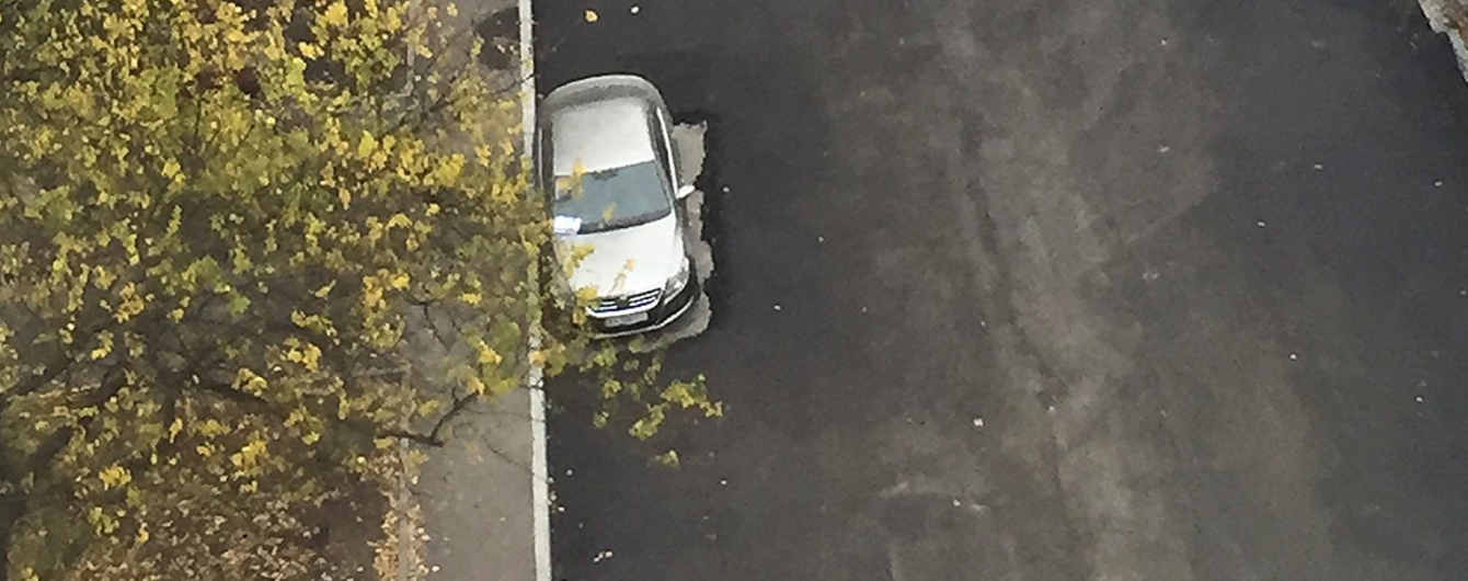 "До эвакуатора не додумались". В Харькове дорожники положили асфальт вокруг машины
