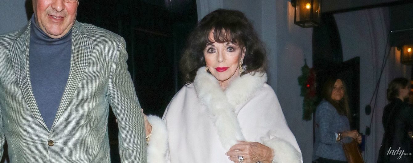 В белой накидке с мехом: 86-летняя Джоан Коллинз на прогулке с супругом