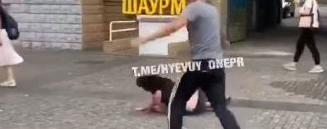 В Днепре мужчина посреди улицы ногами избил женщину, она потеряла сознание: появилось видео