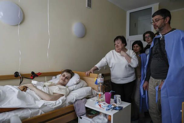 Родина прийшла на святкування дня народження 20-річного Микити, українського військовослужбовця, який був поранений у Бахмуті, у військовий госпіталь у Києві, 5 травня 2023 року. AP Photo/Alex Babenko