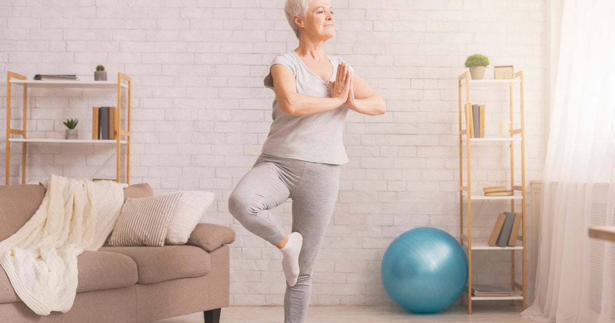 Літня жінка займається йогою