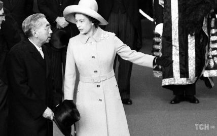 Этот день в истории: королева Елизавета II в пальто и забавной шляпе на встрече с императором