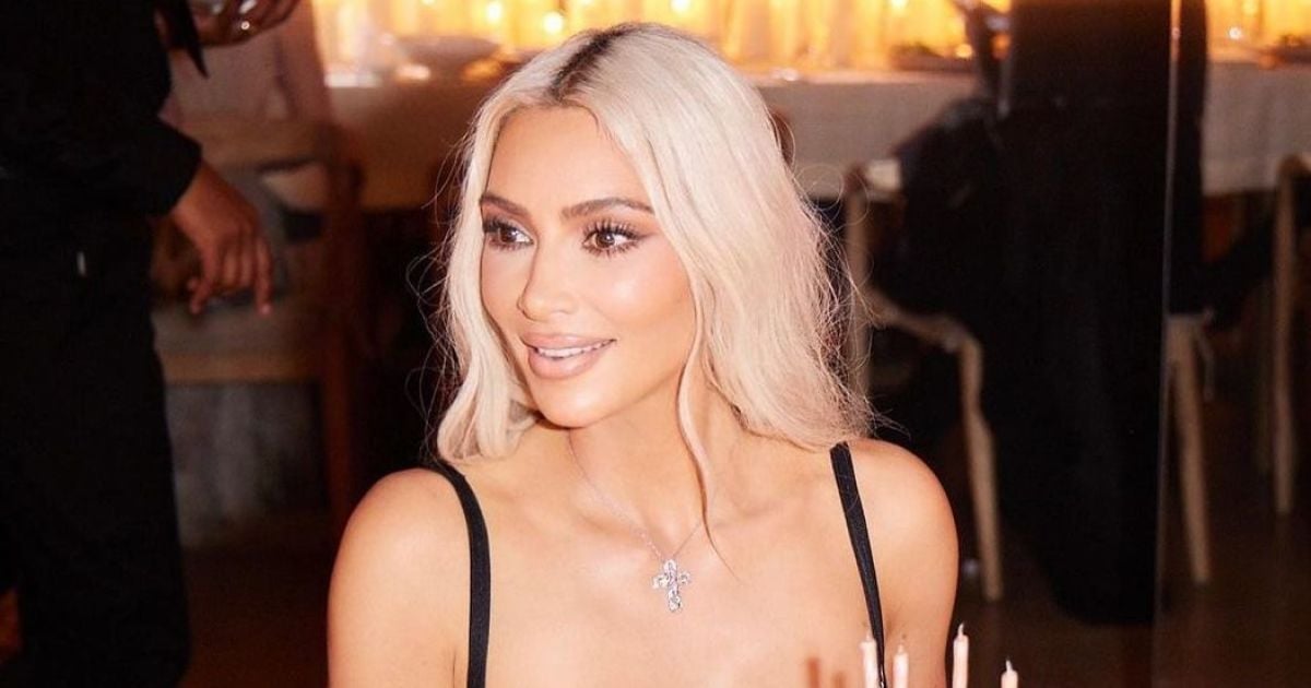 In a transparent dress and with a cross on her neck Kim Kardashian