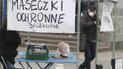 Борясь с нехваткой защитных масок от распространения коронавирус, частная фирма продает хлопковые маски на улице в Варшаве.