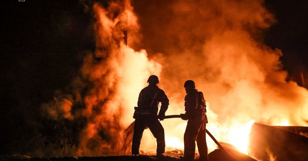 Rescuers are extinguishing the fire after the drone strike in Nizhyn