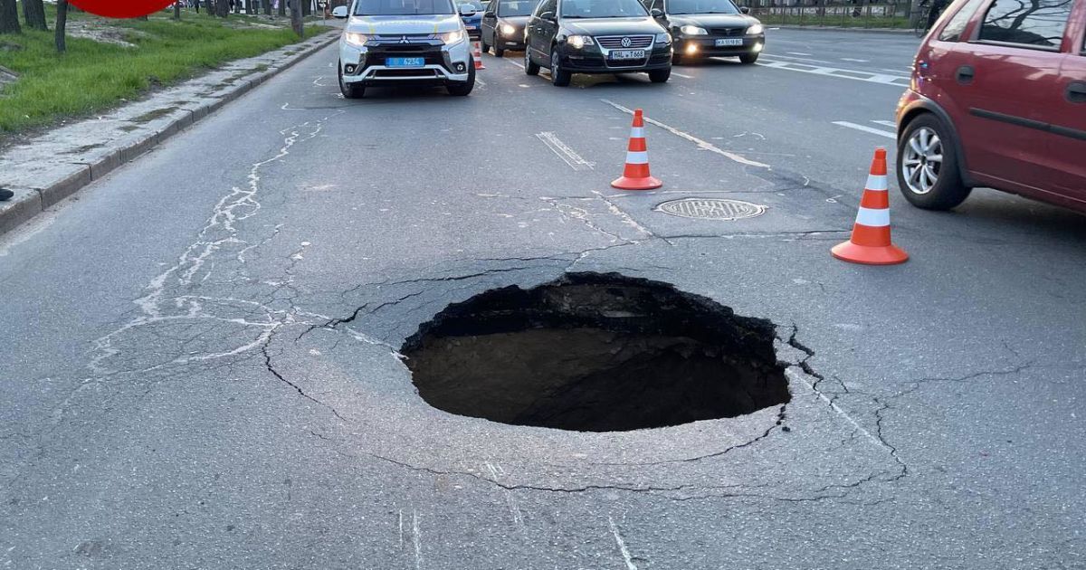 "Портал в підземелля": у Києві посеред дороги утворилось величезне провалля (фото)