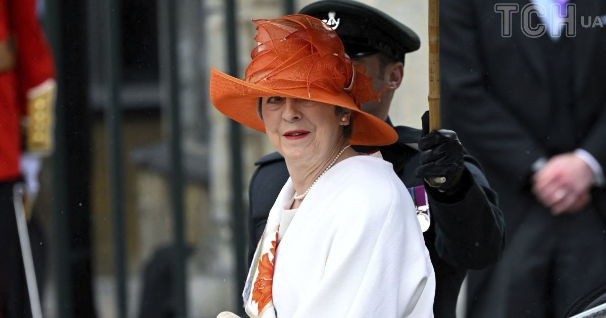 In an orange hat and with a red manicure: Theresa May's spectacular ...