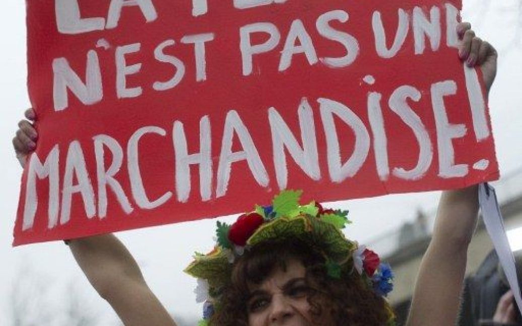 Швейцарія, Цюріх. Швейцарська активістка українського жіночого руху FEMEN тримає плакат з написом "Жінка &mdash; не товар" під час топлес-протесту, який FEMEN влаштував на найбільшій вулиці сутенерів у Цюриху. Дівчата виступили за боротьбу з проституцією і проти торгівлі жінками. / © AFP