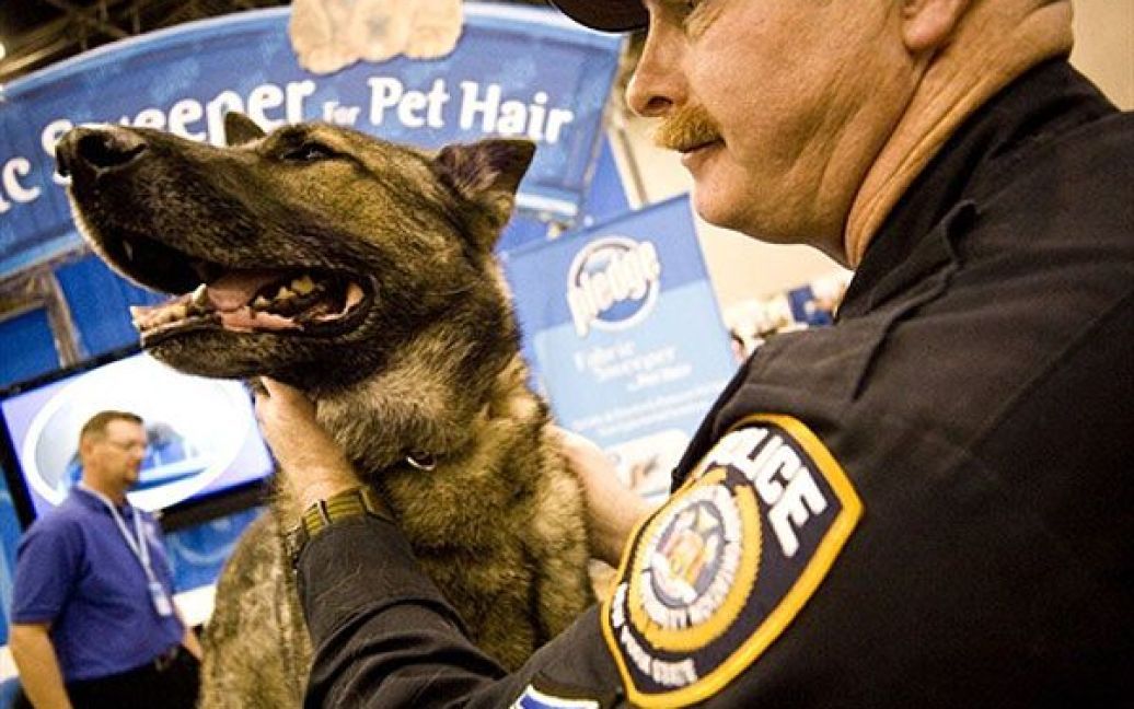 Офіцер зі своїм службовим собакою на виставці. / © AFP