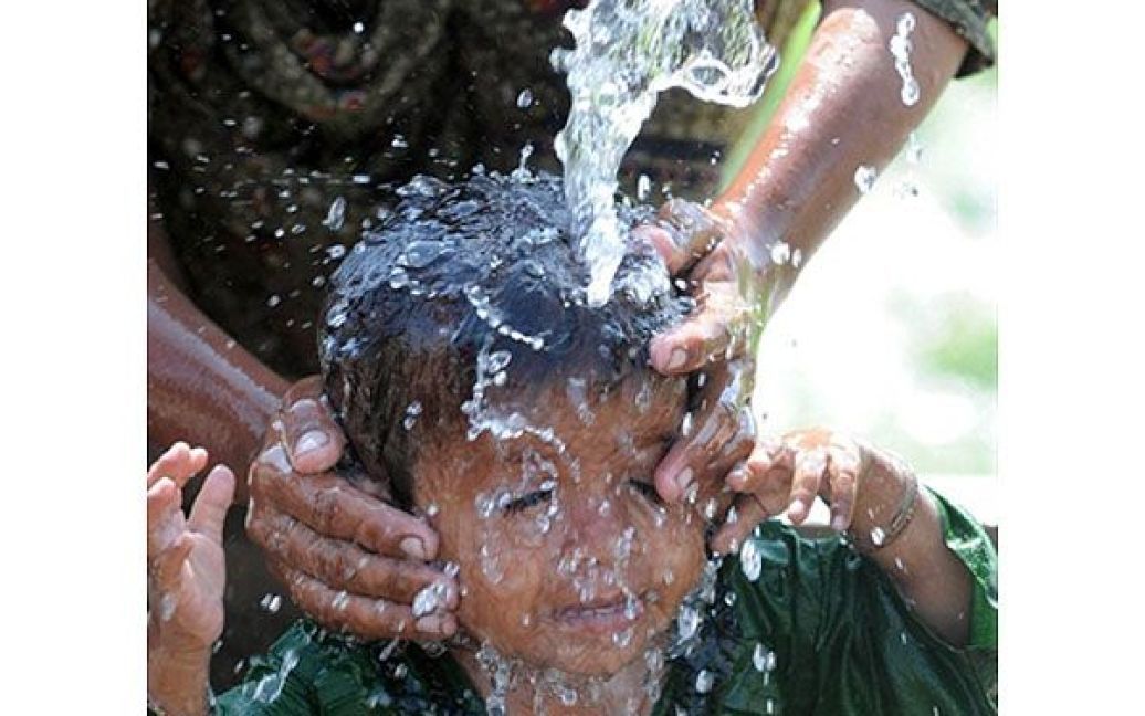 Пакистан, Суккур. Пакистанську дитину купають у наметовому таборі Суккур. Пакистан продовжує боротьбу з наслідками руйнівної повені, від якої, за оцінками ООН, постраждали близько 21 мільйонів людей і 12 мільйонів потребують надзвичайної продовольчої допомоги. / © AFP