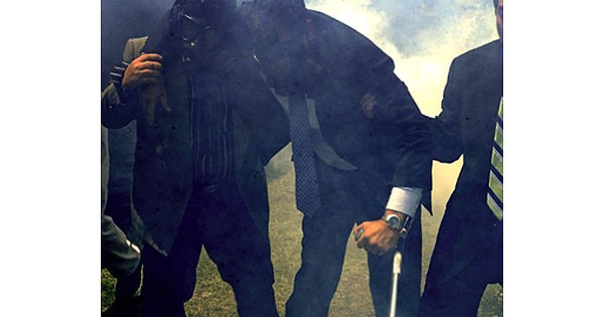 Еквадор, Кіто. Президента Еквадору Рафаеля Корреа (у протигазі) евакуюють з приміщення казарми Рехімьєнто у місті Кіто. Президент Еквадору Рафаель Корреа постраждав від гранат зі сльозогінним газом, які були кинуті поліцейськими під час масової акції протесту в Кіто, коли близько 800 людей захопили центральну поліцейську казарму. Жертвами заворушень в Еквадорі стали щонайменше троє людей, кількість постраждалих перевищила 70 осіб. / © AFP