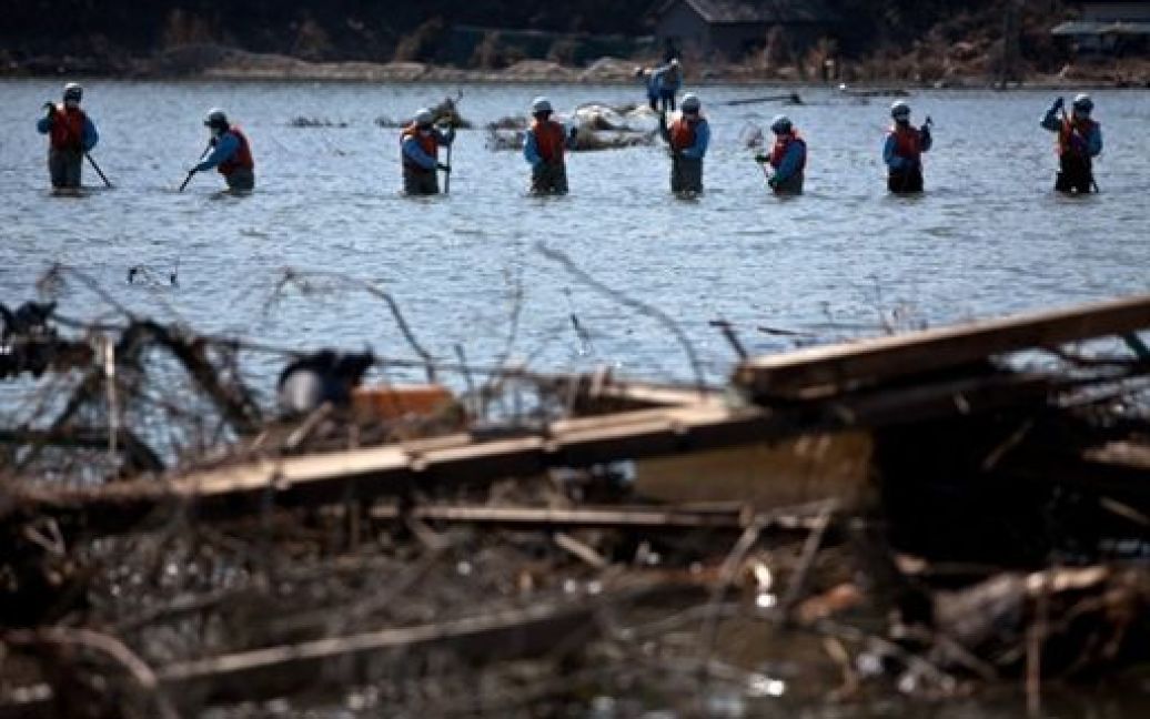 Японія, Ісіномакі. Японські пожежні розшукують у воді тіла загиблих від цунамі в затопленому районі Ісіномакі, префектура Міягі. / © AFP