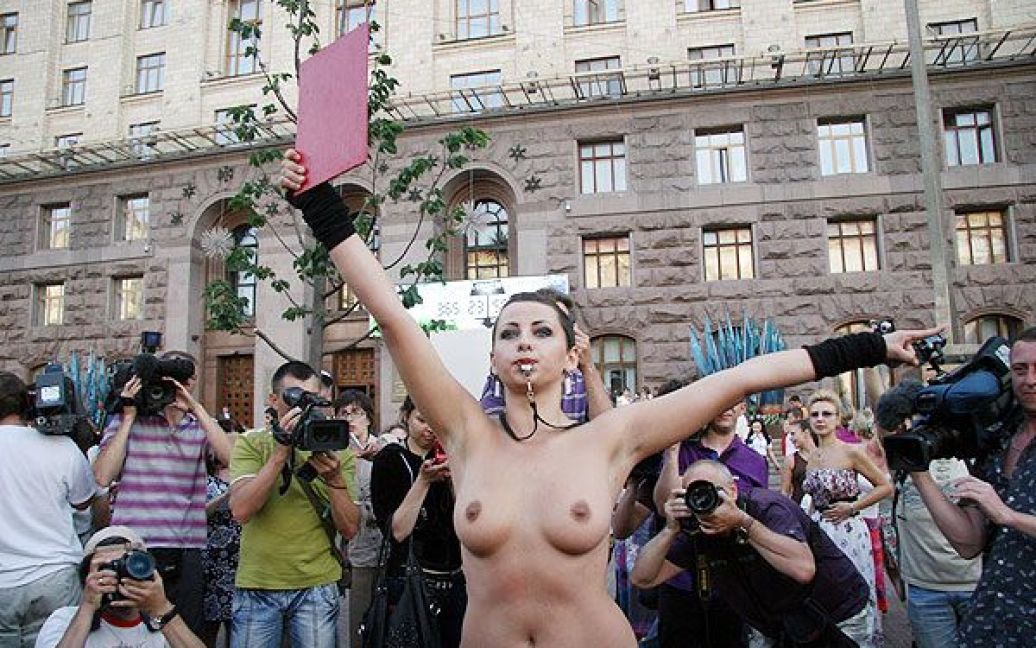 Оголена дівчина з написом на спині "Євро-2012 без проституції" свистіла в суддівський свисток і показувала присутнім червону картку / © Жіночий рух FEMEN