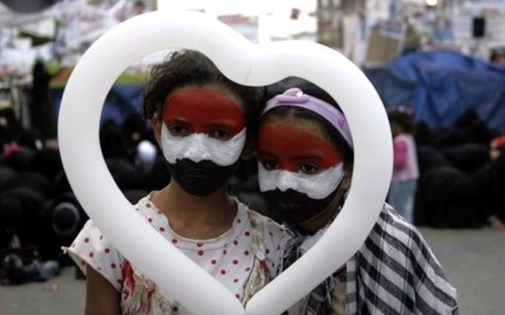 Ємен, Сана. Єменські дівчата з обличчями, пофарбованими у кольори національного прапору, беруть участь у щоденній демонстрації проти уряду і закликають до повалення президента країни Алі Абдалли Салеха. / © AFP