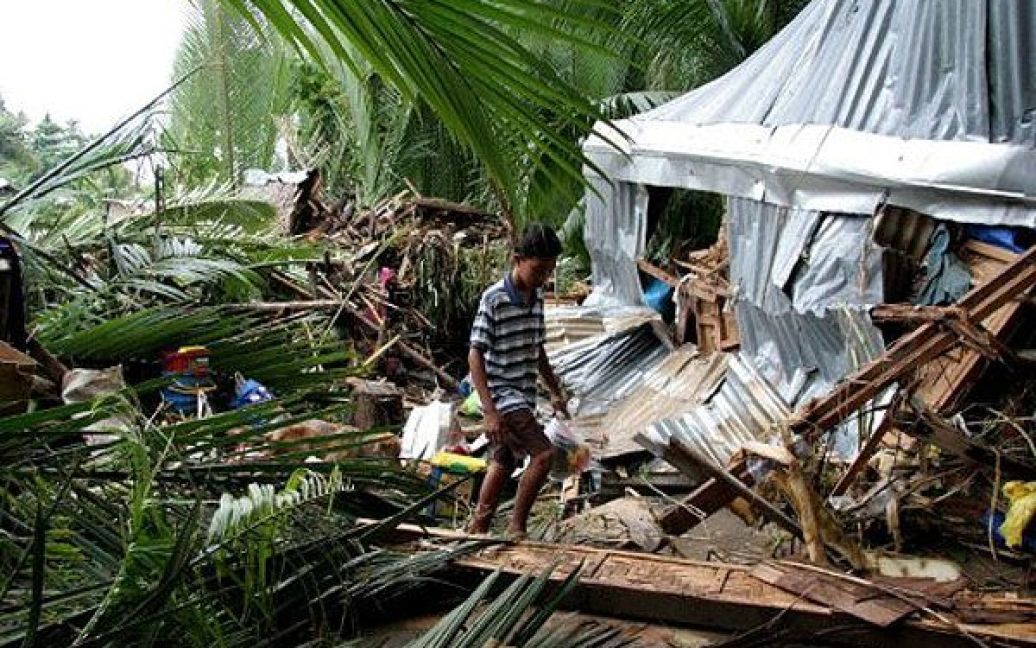 Філіппіни, Давао. Хлопчик проходить повз пошкоджений будинок в місті Давао, який знесло під час повені. В результаті повені 19 осіб загинули, 15 осіб зникли без вісті. / © AFP