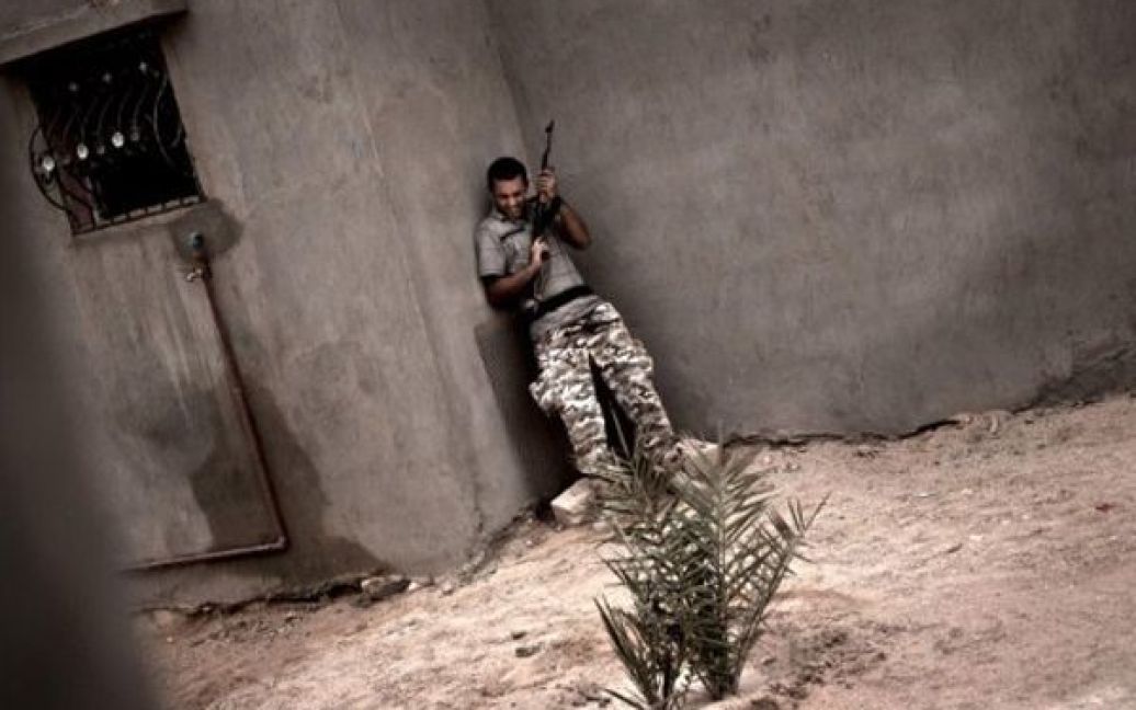 Лівійська Арабська Джамахірія, Джош. Бойовик ховається від вогню під час бою у місті Джош. Останній місяць на заході Лівії точаться запеклі бої через намагання повстанців прорватися до Тріполі. / © AFP