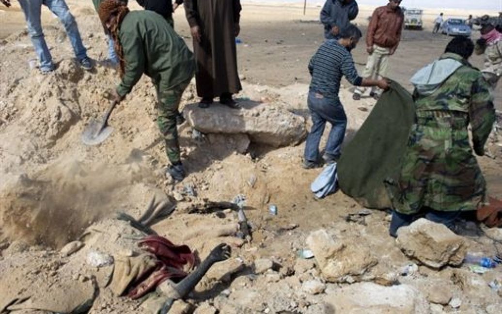 Лівійська Арабська Джамахірія, Аждабія. Бойовики ховають вбитих прихильників лівійського лідера Муаммара Каддафі у братській могилі поблизу західних воріт міста Аждабія. За словами повстанців, близько 35 бійців Каддафі були вбиті під час авіаудару НАТО. / © AFP