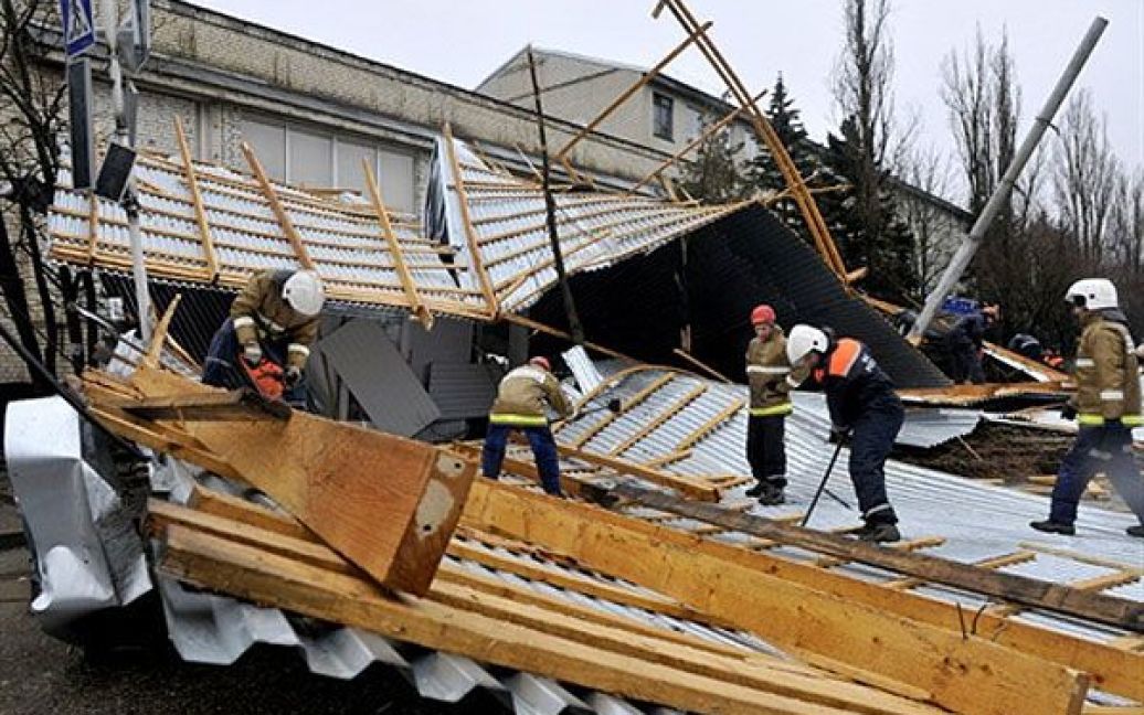 Росія, Ставрополь. Рятувальники МНС Росії розбирають уламки даху, який потужним вітром зірвало з коледжу у Ставрополі . / © AFP