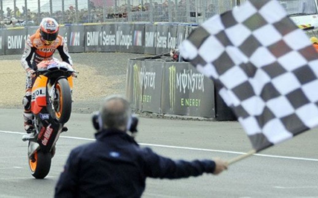 Франція, Ле-Ман. Австралійський мотогонщик Кейсі Стоунер святкує перемогу у Гран-прі Франції Moto GP на треку Ле-Ман, західна Франція. / © AFP