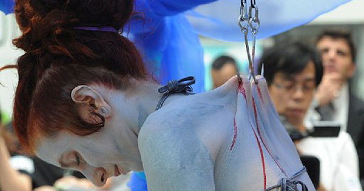 У Гонконгу артистку Еліс Ньюстід підвісили на крюках під час акції на захист акул. / © AFP