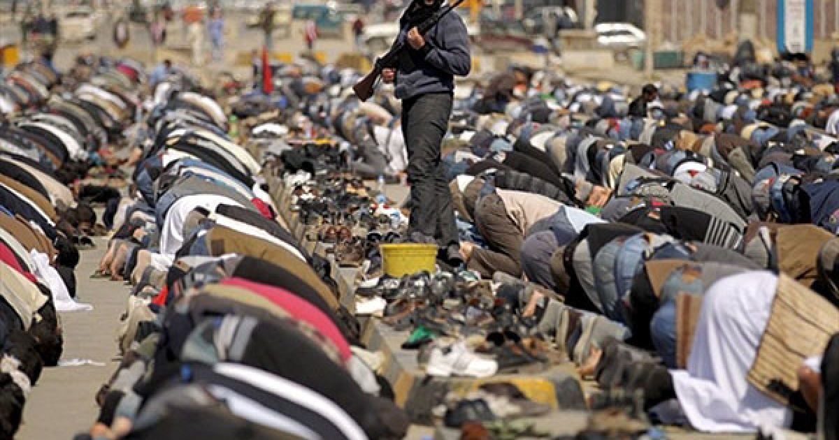 Лівійська Арабська Джамахірія, Бенгазі. Лівійський бойовик охороняє повстанців під час виконання п'ятничної молитви у місті Бенгазі. Коаліційні сили продовжують наносити повітряні удари по військах лівійського лідера Муаммара Каддафі.