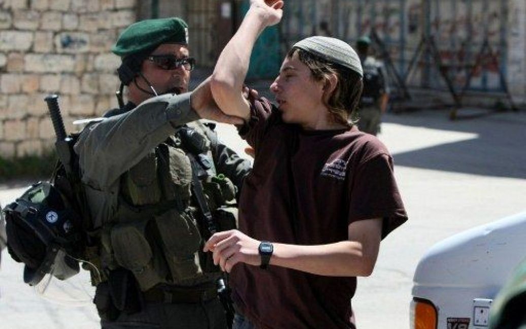 Хеврон. Єврейський поселенець сперечається з ізраїльським поліцейським під час виселення з будинку в Хевроні. / © AFP