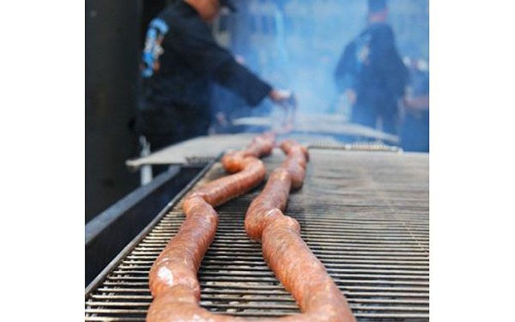 США, Чикаго. 47-метрову рекордну ковбасу приготували на грилі для встановлення рекорду Гіннеса на найдовший хотдог. Для приготування також знадобились 50-метрова булочка. / © AFP
