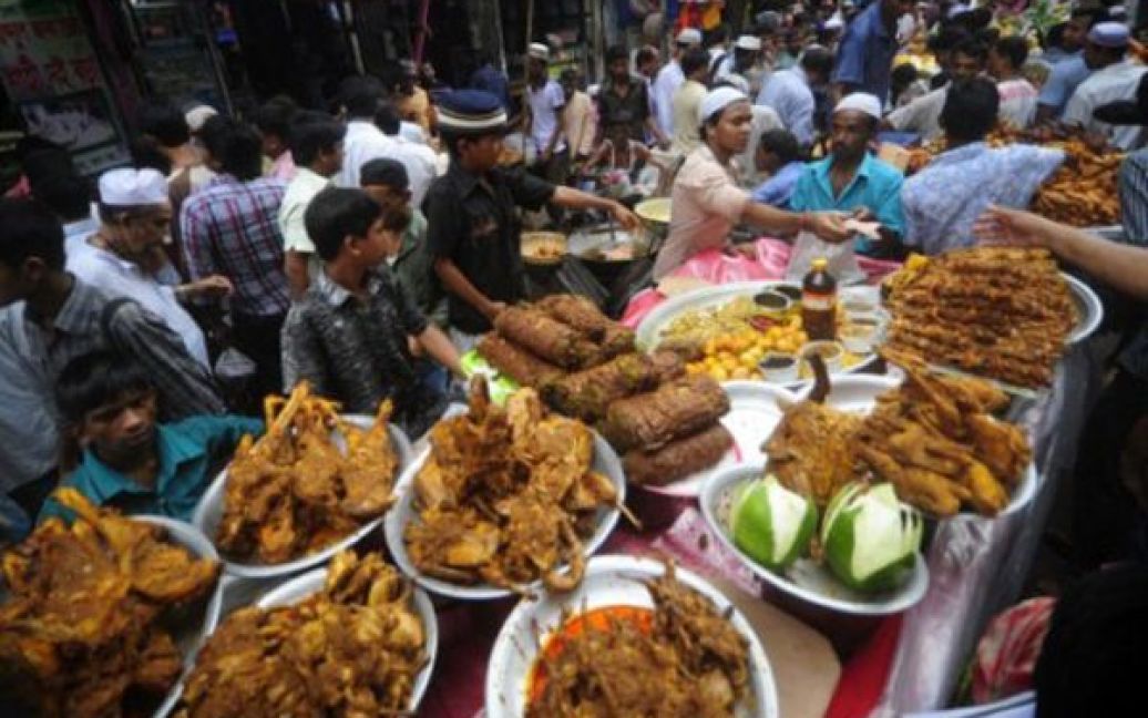 Бангладеш, Дака. Вуличні торгівці розкладають на своїх ятках іфтар, їжу, яку дозволено вживати після заходу сонця під час Рамадану, на старому ринку. / © AFP