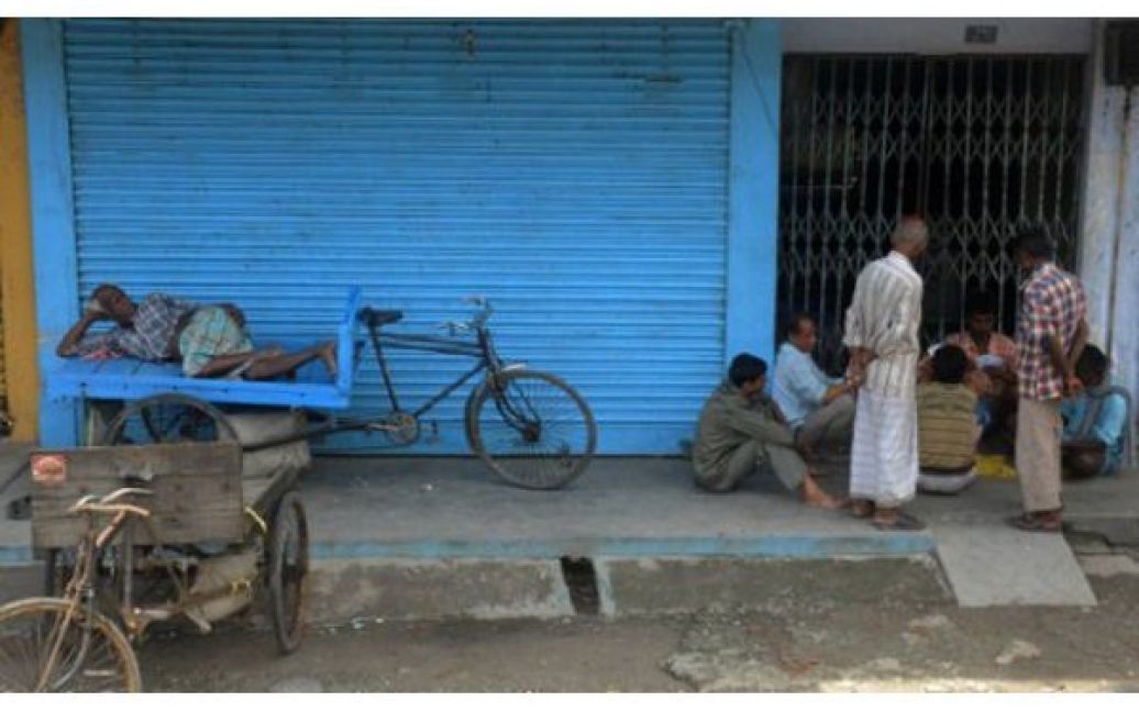 Індія, Сілігурі. Торговці сидять перед зачиненим магазином протягом 12-годинного страйку, організованого Асоціацією профспілок Індії. / © AFP