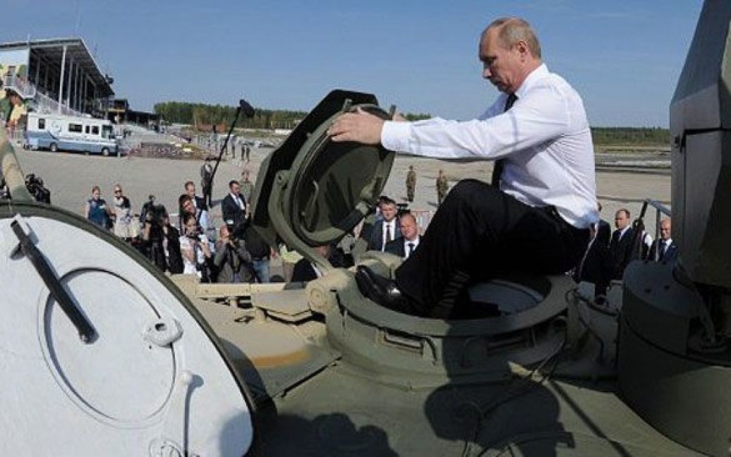 Росія, Нижній Тагіл. Прем&#039;єр-міністр Росії Володимир Путін забирається до танку T-90AM під час візиту на виставку зброї в уральському місті Нижній Тагіл. / © AFP