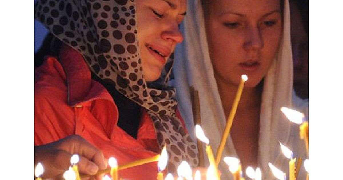 Сотні людей в Ярославлі приносять квіти та запалені свічки до стадіону "Арена-2000", на якому тренувалась команда. / © AFP