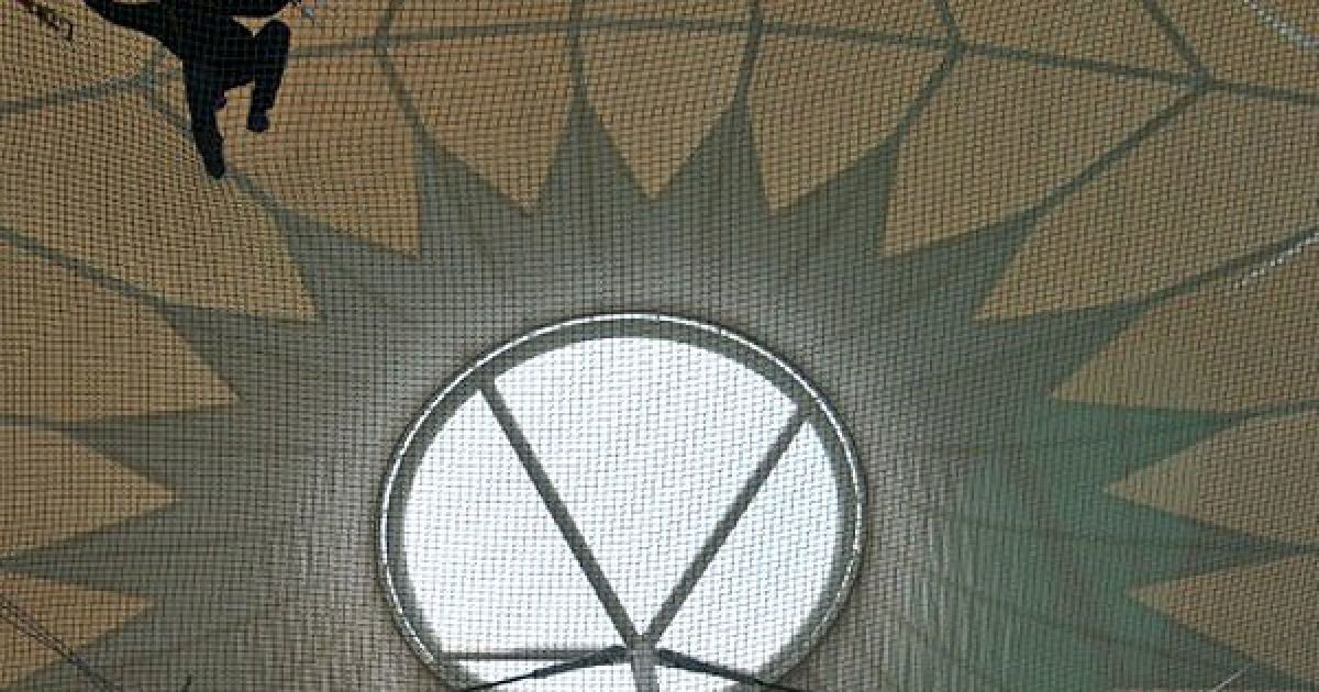 Україна, Київ. Будівельник завершує встановлювати дах-мембрану над реконструйованим стадіоном НСК "Олімпійський", який стане головною ареною чемпіонату ЄВРО-2012. Київ є одним з чотирьох українських міст, які приймають футбольний чемпіонат. / © AFP