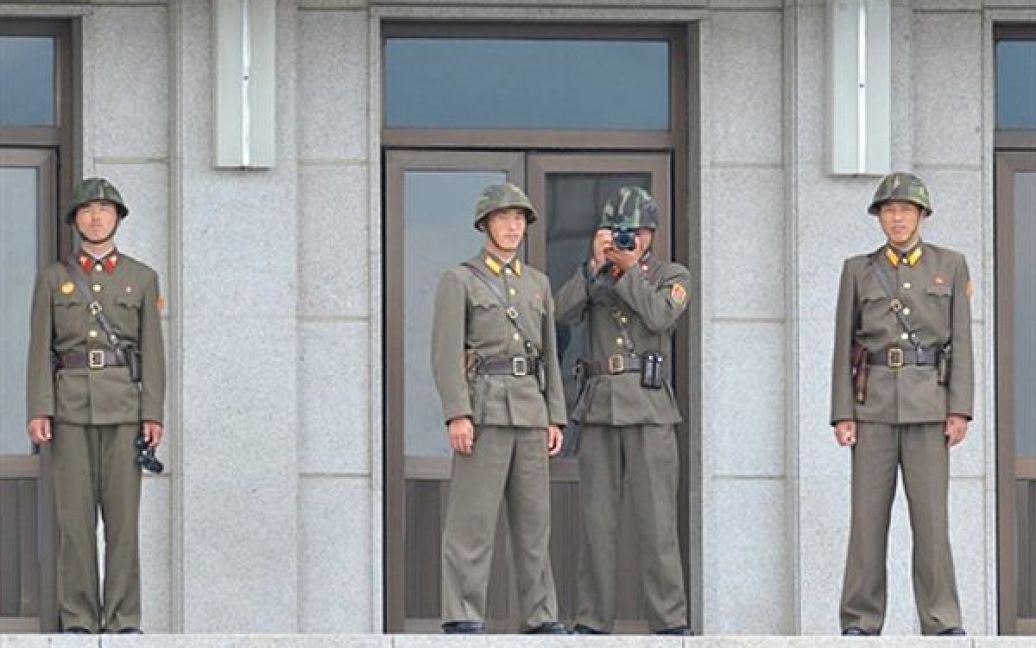Північнокорейські солдати фотографують  як жителі Південної Кореї запускають повітряні кульки із антикомуністичними листівками. Жителі Південної Кореї влаштували у прикордонній зоні демонстрацію та побажали лідеру КНДР Кім Чен Іру якнайшвидшої смерті. / © AFP