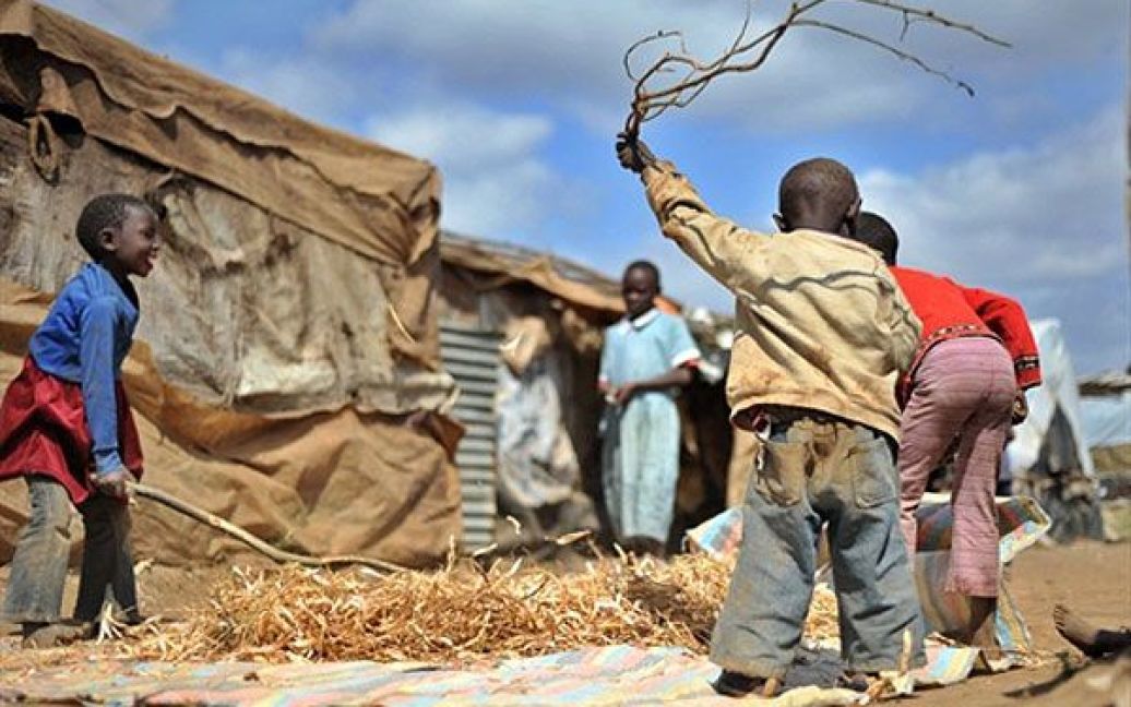 Кенія, Май Майю. Діти палицями вибивають боби зі стручків у таборі для осіб, переміщених всередині країни, "Tumaini" (назва табору з мови суахілі перекладається, як "надія"), розташованому біля міста Найваша. Проведення довгоочікуваного конституційного референдуму в Кенії призвело до того, що у "внутрішніх" біженців, які постраждали від етнічних зіткнень у ході президентських виборів у 2008-2009 роках, виникли нові побоювання за свою безпеку. Деякі кенійські "внутрішні мігранти" з різних частин країни досі не можуть повернутися до своїх будинків, оскільки вони побоюються нападів з боку тих, хто дотримується інших політичних уподобань. / © AFP