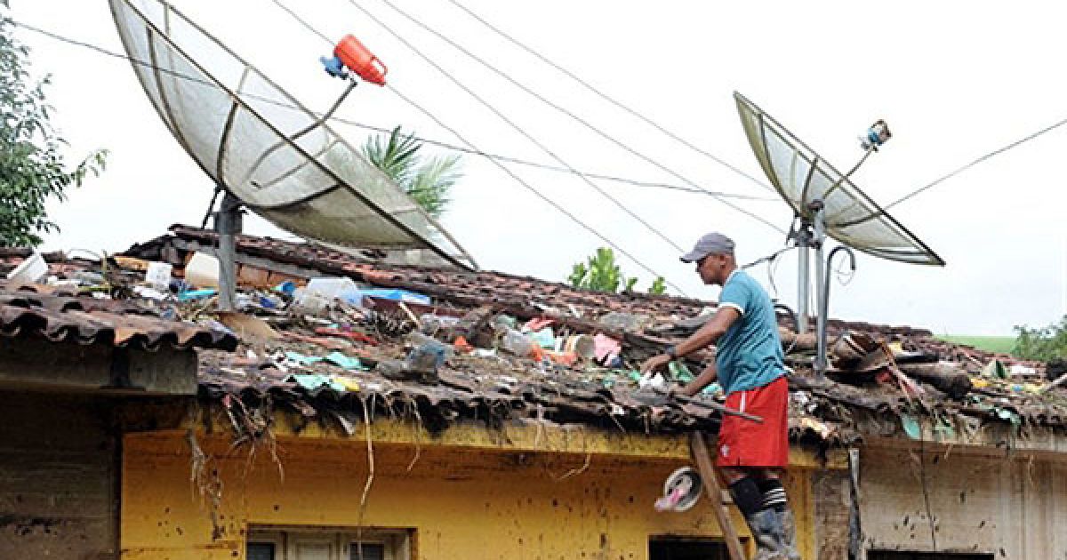 Бразилія, Бранкіньо. Чоловік очищає дах свого будинку після повені, яку спричинив вихід з берегів річки Мандал. У бразильському штаті Алагоас тривають рятувально-пошукові роботи. Кілька сотень людей зникли безвісті в результаті повені, що охопила північний схід Бразилії, щонайменше 44 людини загинули. / © AFP