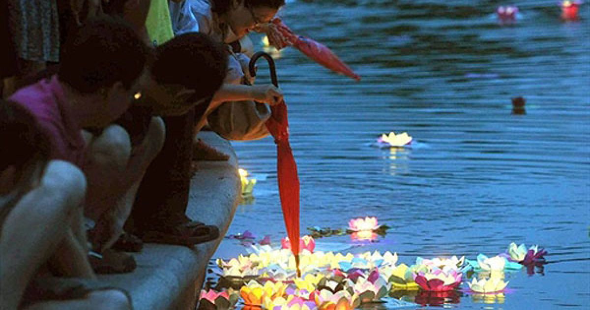Китай, Пекін. Китайські сім'ї збираються на березі озера при свічках, щоб пустити на воду квіти лотоса і побажати щастя під час свята Дуанву, відомого також як свято човнів-драконів. У Китаї свято Дуанву було відновлено, як офіційне державне свято, тільки у 2008 році. Традиційно це свято відзначають у багатьох китайських громадах Східної Азії і Південно-Східної Азії. / © AFP