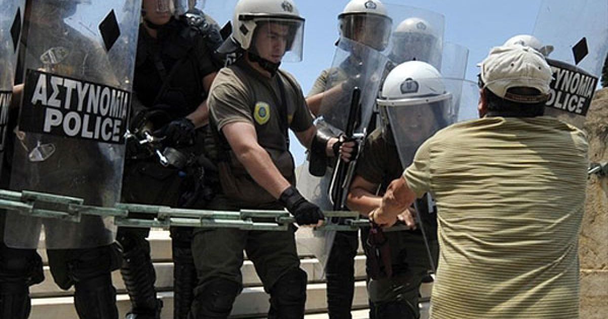 Демонстрант намагається прорватись крізь поліцейський кордон до будівлі парламенту / © AFP