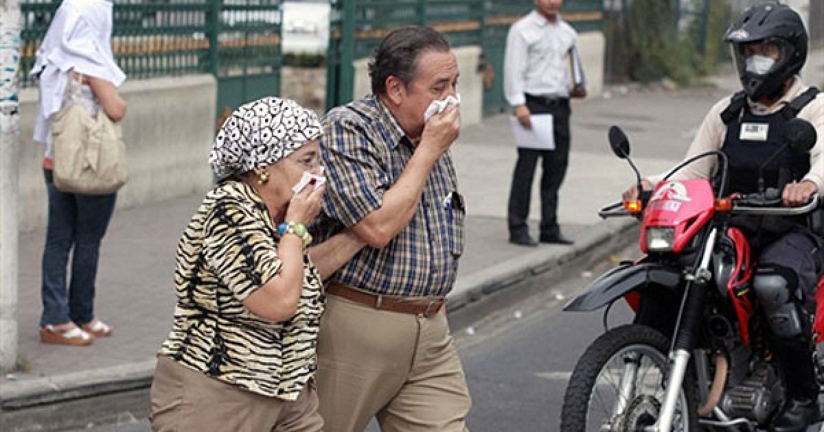 Місцеві мешканці виходять на вулицю, закриваючи обличчя масками. / © AFP