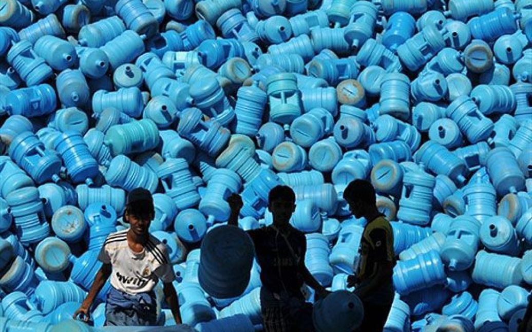 Саудівська Аравія, Мекка. Саудівські хлопчики сортують контейнери для води "замзам" у Мецці. Загідно ісламської віри, "замзами" є дивовижним джерелом води від Бога, яке з&rsquo;явилось тисячі років тому. Мільйони прочан кожного року під час виконання хаджу п&rsquo;ють саме цю воду. / © AFP