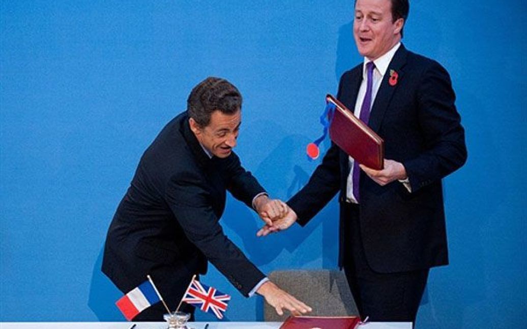 Великобританія, Лондон. Президент Франції Ніколя Саркозі і прем&#039;єр-міністр Великобританії Девід Кемерон жартують після підписання договору про співпрацю в області оборони, яке відбулось в рамках англо-французької зустрічі на вищому рівні у Лондоні. / © AFP