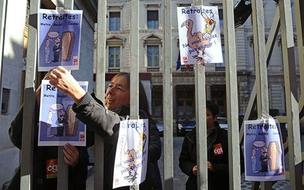 Франція, Тулуза. Працівник Французького національного банку тримає плакат "Пенсії: не дозволяйте здирати з себе шкіру" під час акції протесту проти урядової пенсійної реформи перед "Банк де Франс" у Тулузі. / © AFP