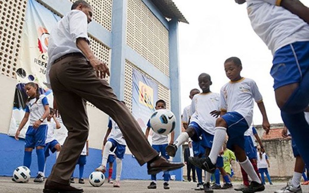 Бразилія, Ріо-де-Жанейро. Президент США Барак Обама грає у футбол з дітьми під час візиту до нетрів "Місто Бога" у Ріо-де-Жанейро. Барак Обама з родиною відвідав Бразилію з офіційним візитом. / © AFP
