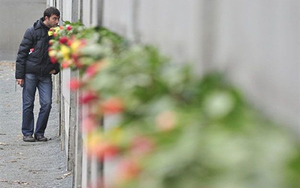 Німеччина, Берлін. Квіти на вшанування пам&#039;яті жертв приносять до залишків Берлінської стіни з нагоди 21-ї річниці падіння Берлінської стіни. / © AFP