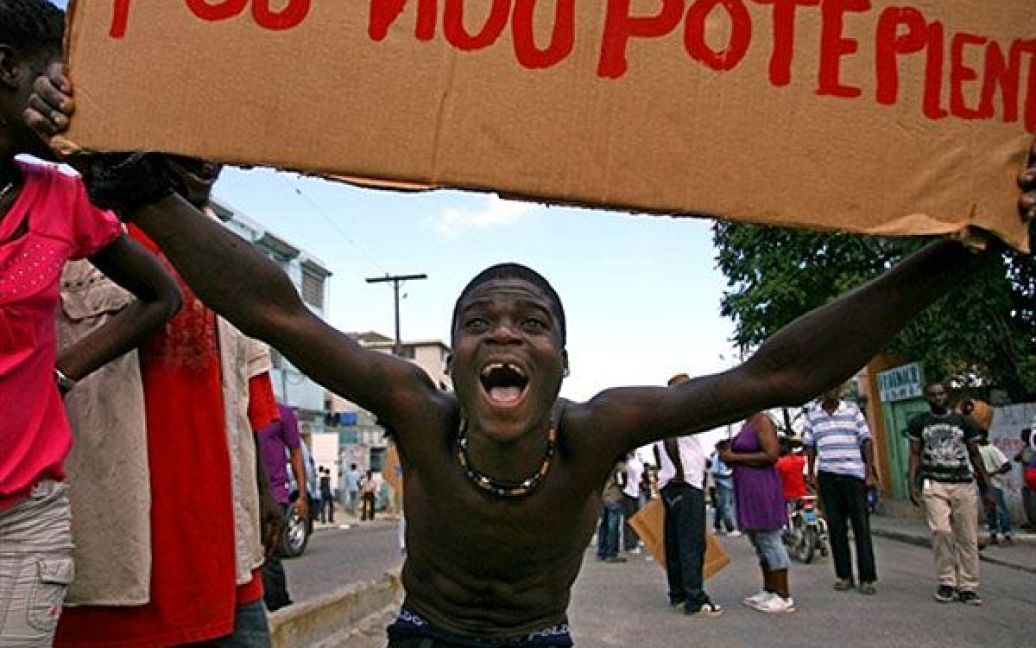 Гаїті, Порт-о-Пренс. Чоловік кричить під час акції протесту у Порт-о-Пренсі. Жителі столиці Гаїті провели масові вуличні акції протесту, до яких їх закликали кандидати у президенти. Вони вимагають анулювати результати виборів, що відбулись у листопаді 2010 року, через масові звинувачення у шахрайстві. / © AFP