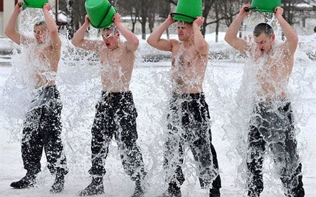 Білорусь, Мінськ. Білоруські солдати внутрішніх військ обливаються холодною водою під час церемонії прийняття присяги у Мінську. / © AFP