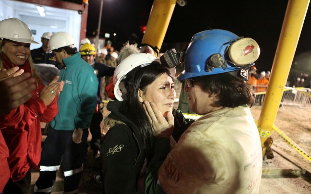 Чилійський шахтар Осман Арайя обіймає свою дружину Анжеліку, після того, як його витягнули з шахти. 33 шахтарі провели у підземній пастці поблизу Копіапо 69 діб. (HUGO INFANTE / AFP / Getty Images) / © The Boston Globe