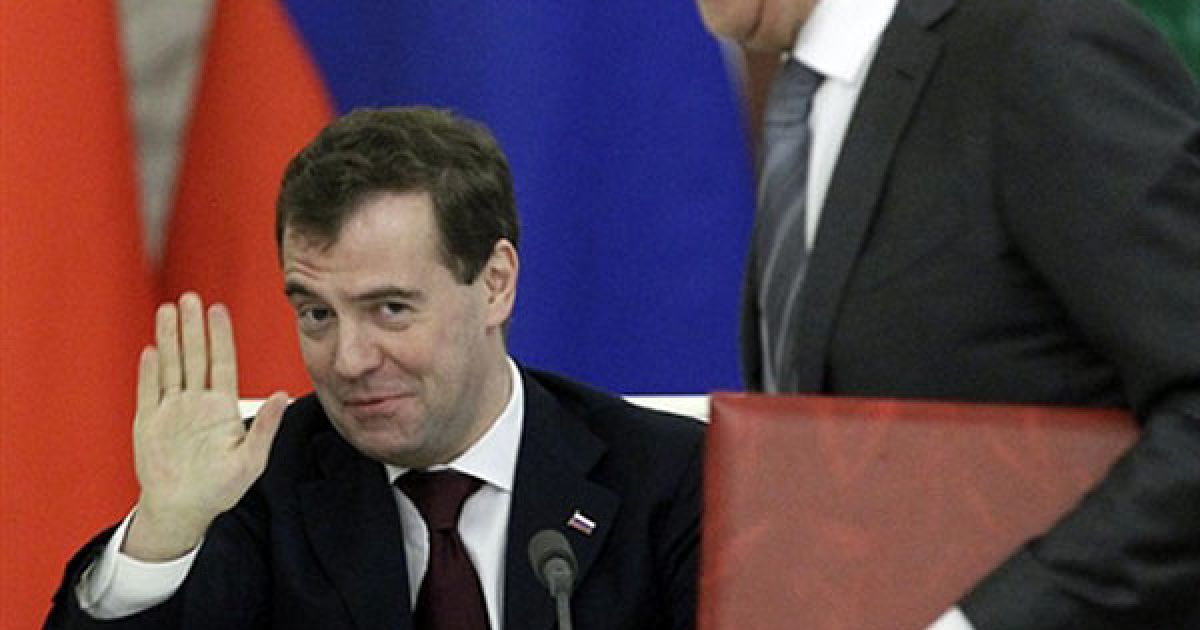 Росія, Москва. Президент Росії Дмитро Медведєв жестикулює, доки міністр закордонних справ Росії Сергій Лавров і його турецький колега Ахмет Давутоглу обмінюються документами про спрощення візових процедур під час церемонії підписання. / © AFP