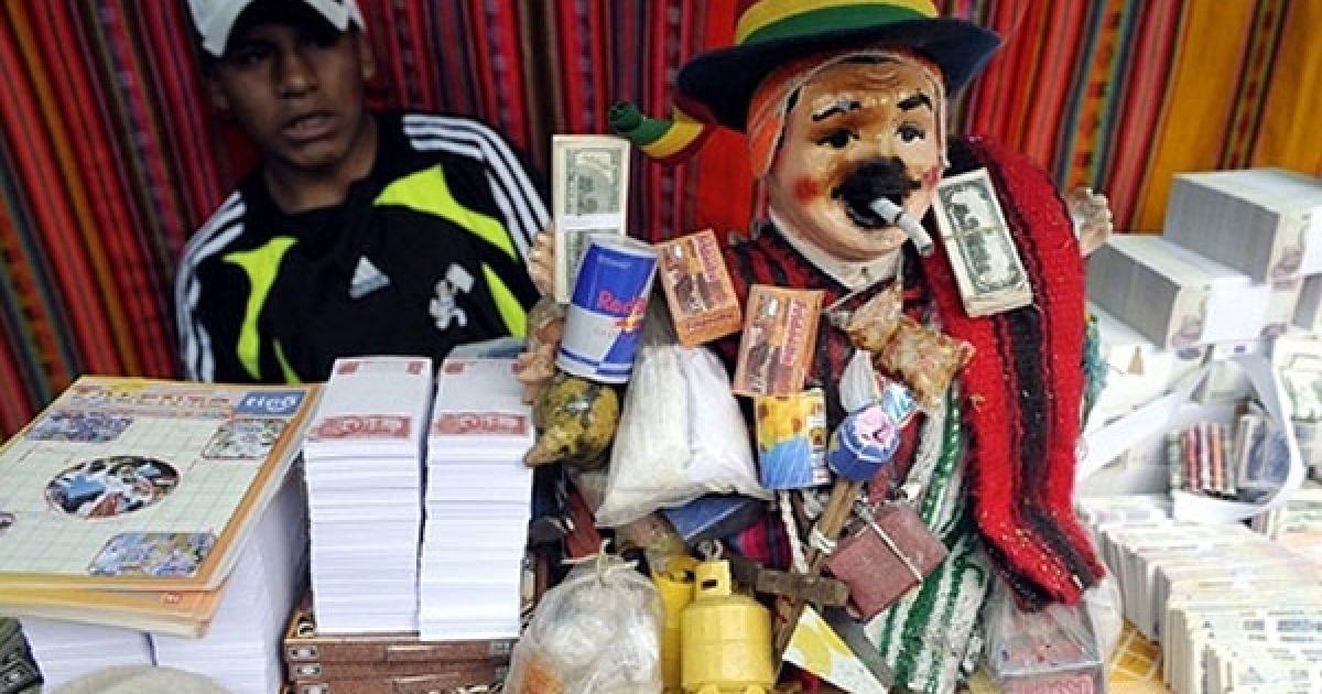 Болівія, Ла-Пас. Чоловік продає підробні гроші під час фестивалю Аласітас на честь аймарського бога достатку Екеко. Під час щорічного свята болівійці купують мініатюрні копії речей, які вони хочуть мати наступного року, і пропонують їх Екеко. / © AFP